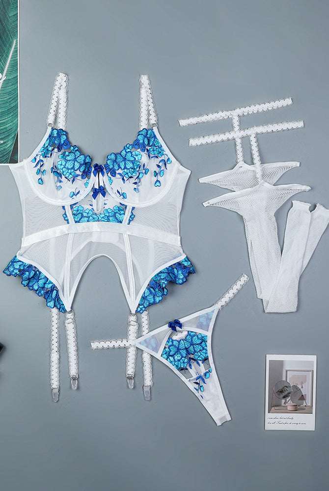 White floral embroidered corset set with blue details, lace, and stockings.