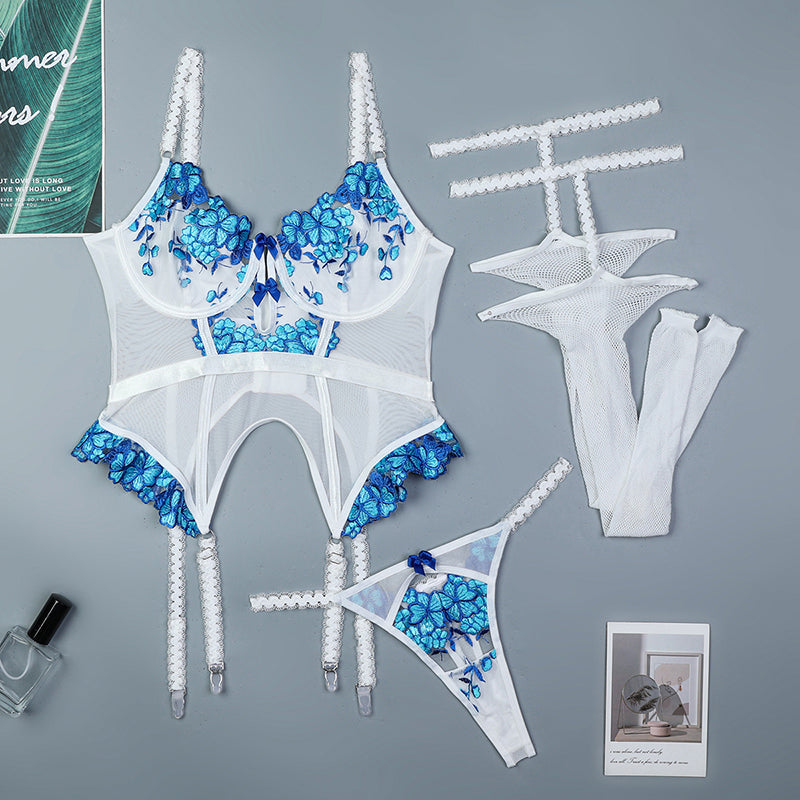 White floral embroidered corset set with blue details, lace, and stockings.