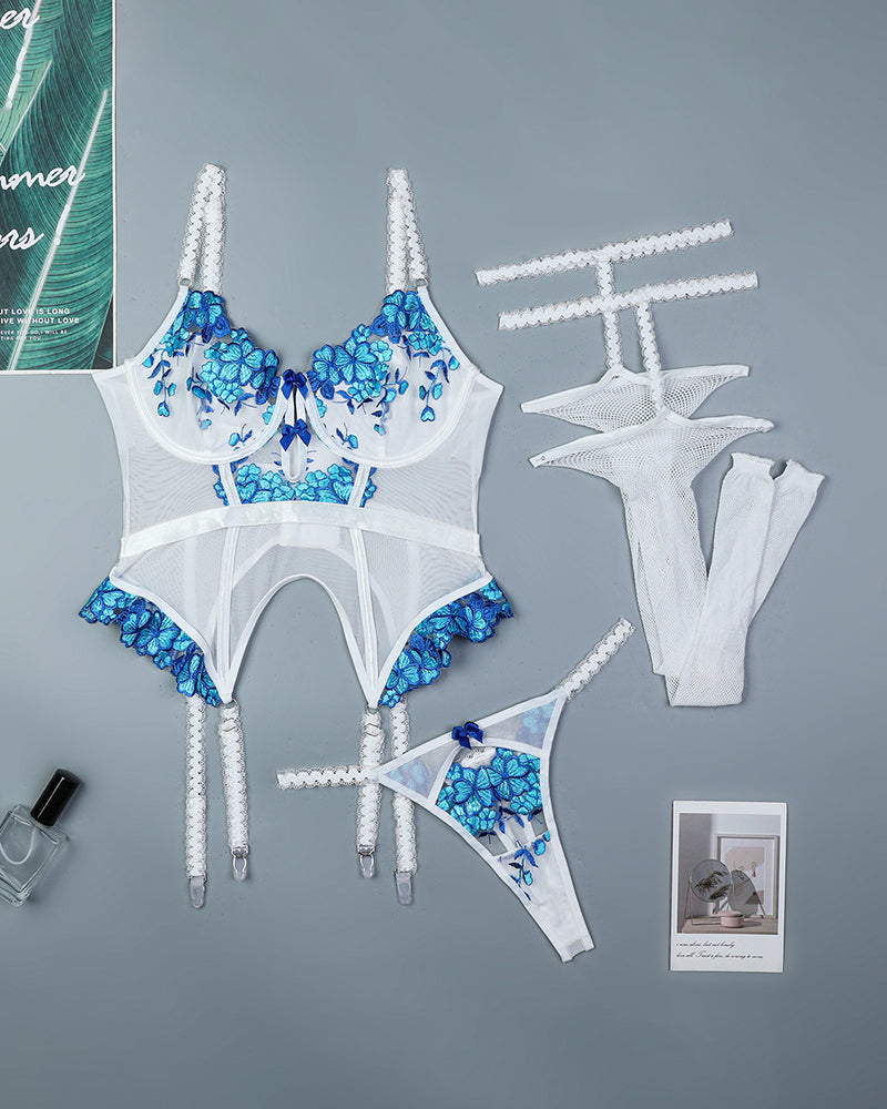 White floral embroidered corset set with blue details, lace, and stockings.