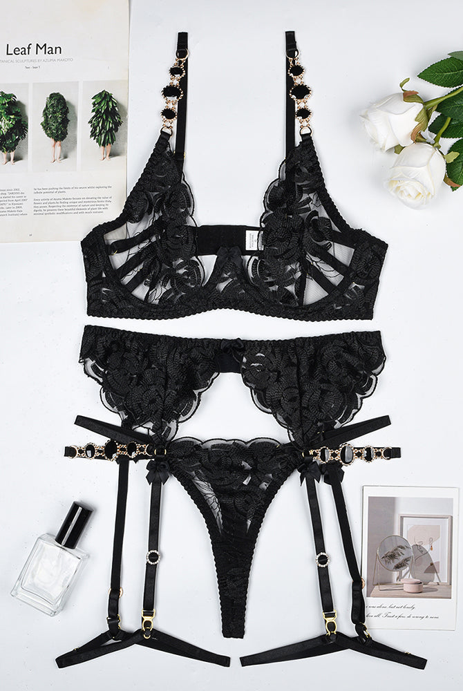 Vintage black gemstone lace lingerie set with floral embroidery; bra, thong, and garter belt.