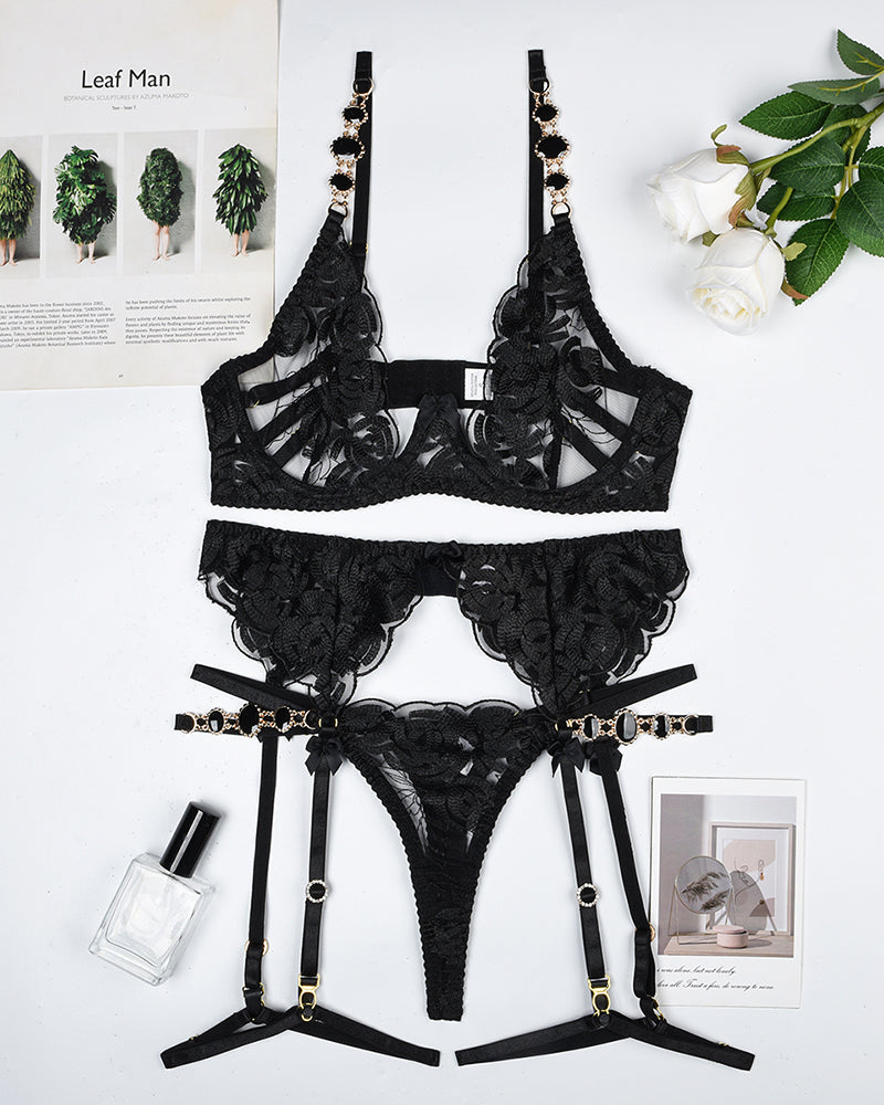 Vintage black gemstone lace lingerie set with floral embroidery; bra, thong, and garter belt.