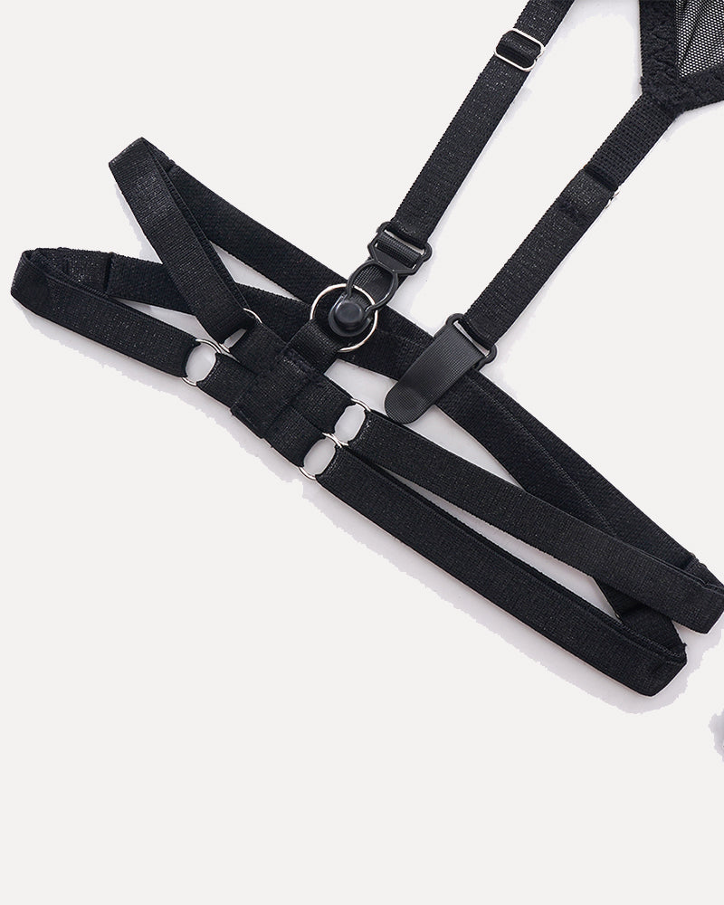 Black lingerie harness with adjustable straps and metal ring details. Sensual lingerie design.