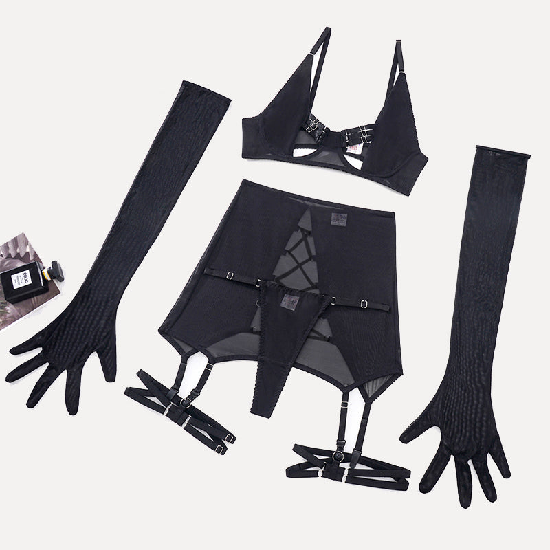 Black lingerie set accessories flat lay: bra, garter skirt, gloves and straps