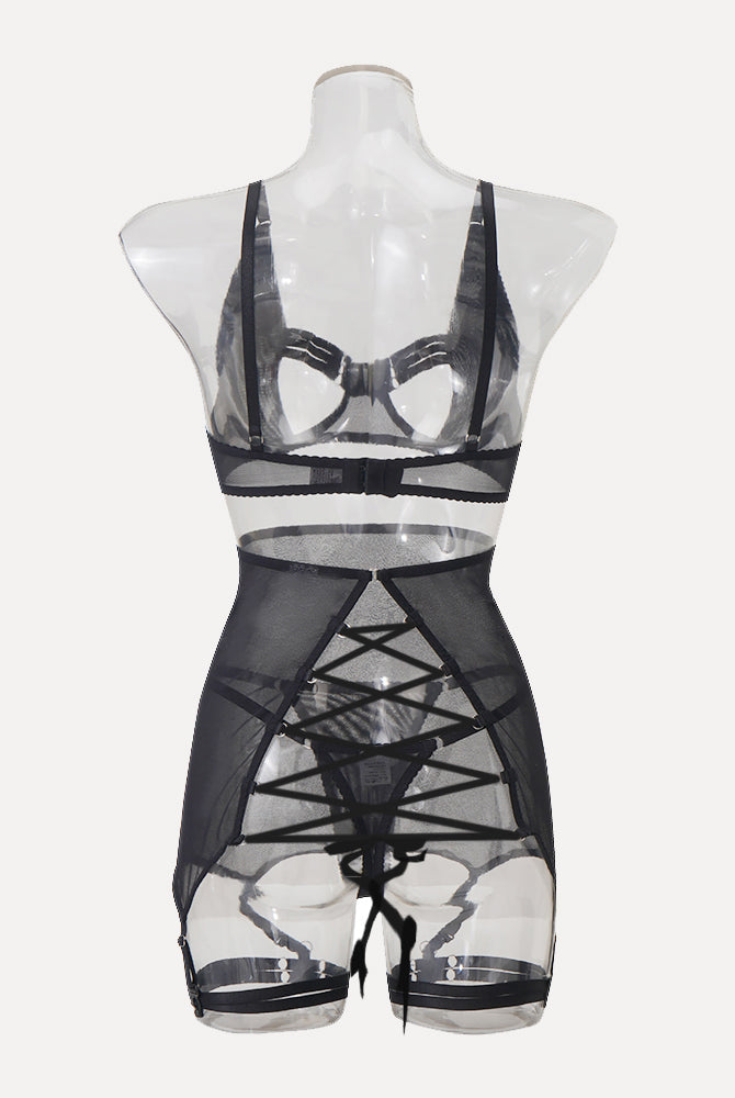 Black lingerie set with sheer skirt, open-bust bra, and garter straps. Sensual and elegant design.
