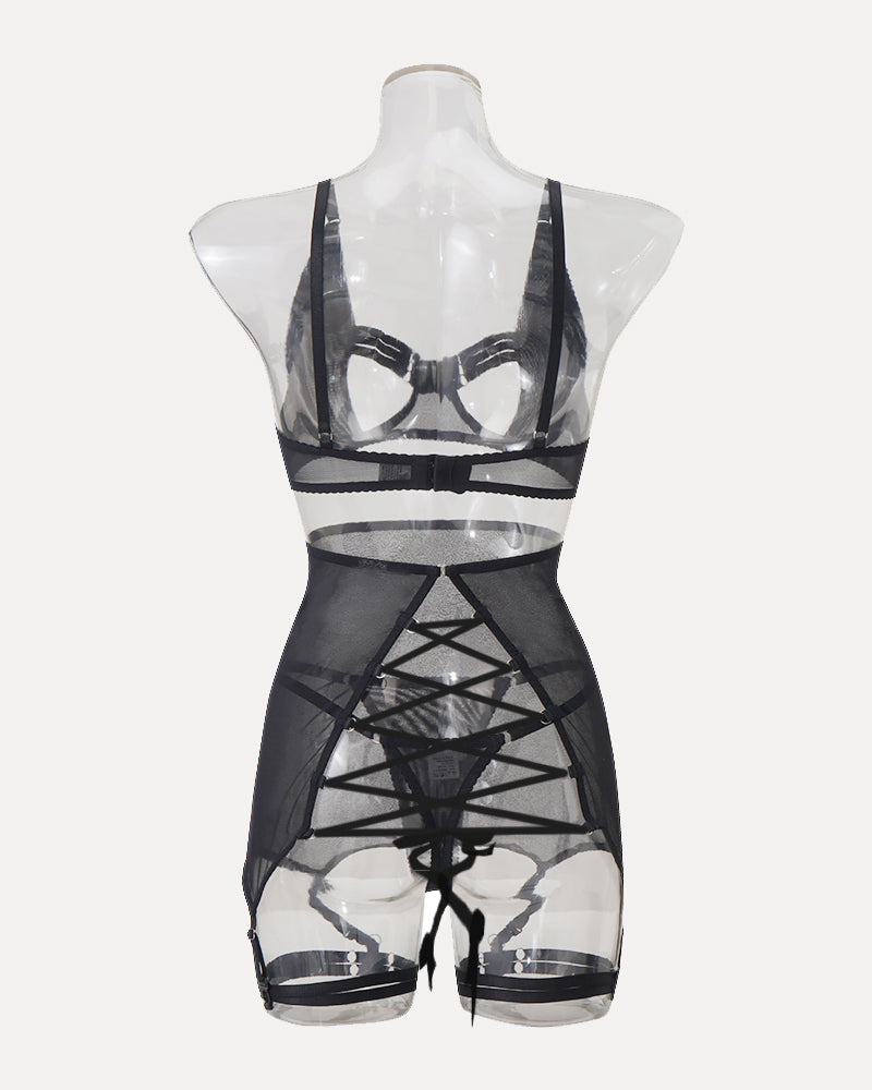 Black lingerie set with sheer skirt, open-bust bra, and garter straps. Sensual and elegant design.
