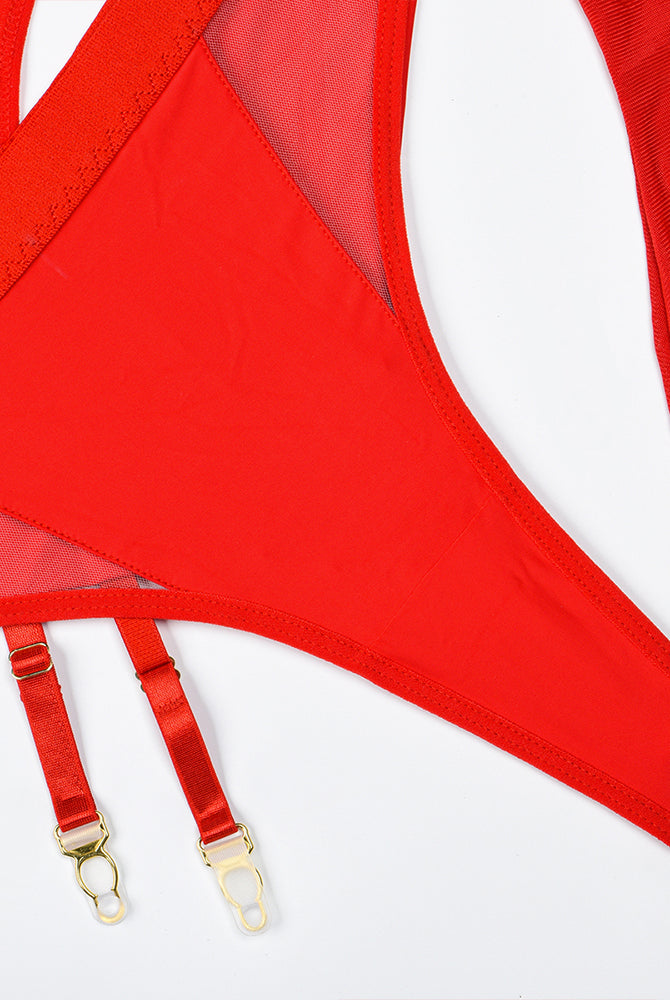 Red garter straps with gold-tone clasps attached to lingerie panel