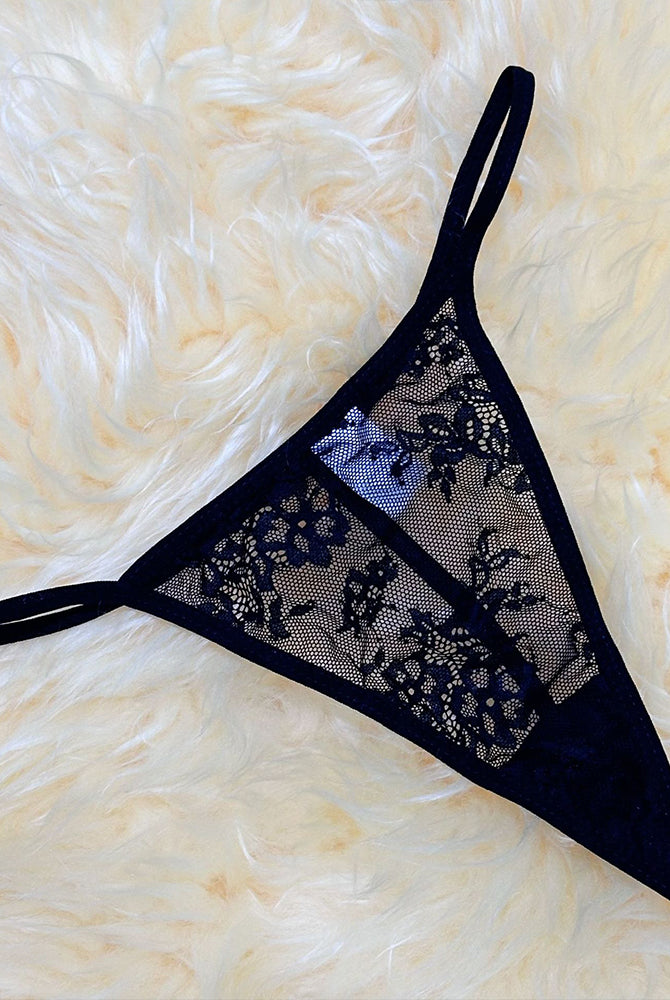 Black lace thong with mesh panel, floral embroidery, and thin adjustable straps
