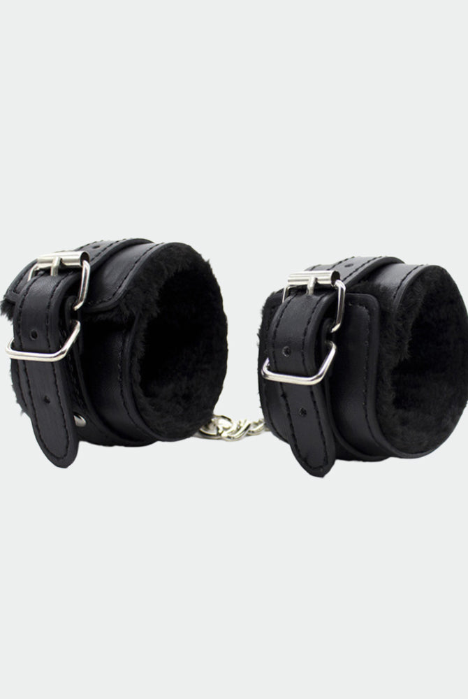 Black leather plush wrist handcuffs with silver buckles for intimate role play and sensual moments.