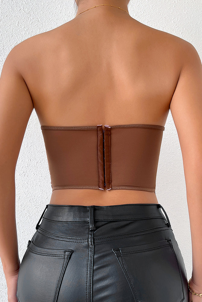 Brown strapless mesh bustier, offering waist shaping and support, paired with black leather pants.