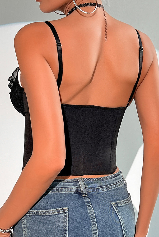 Black corset top with lace trim and adjustable straps, paired with blue jeans