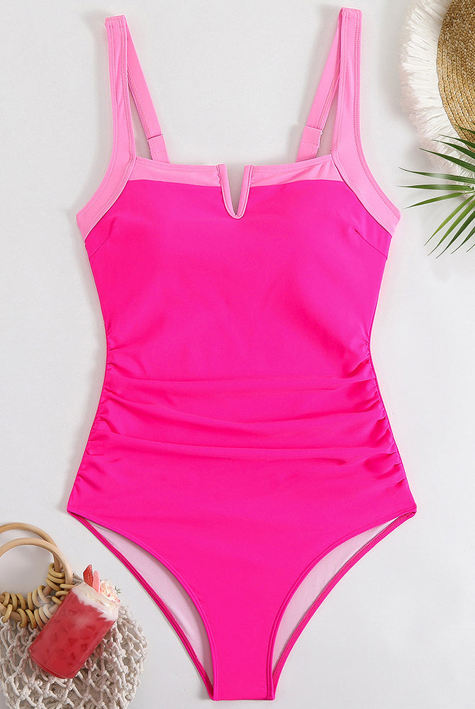 Pink one-piece swimsuit with square neckline, contrast straps, and high-leg cut