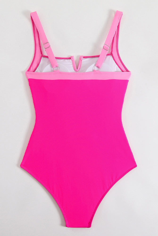 Pink push-up one-piece swimsuit with open V accent at bust and adjustable straps