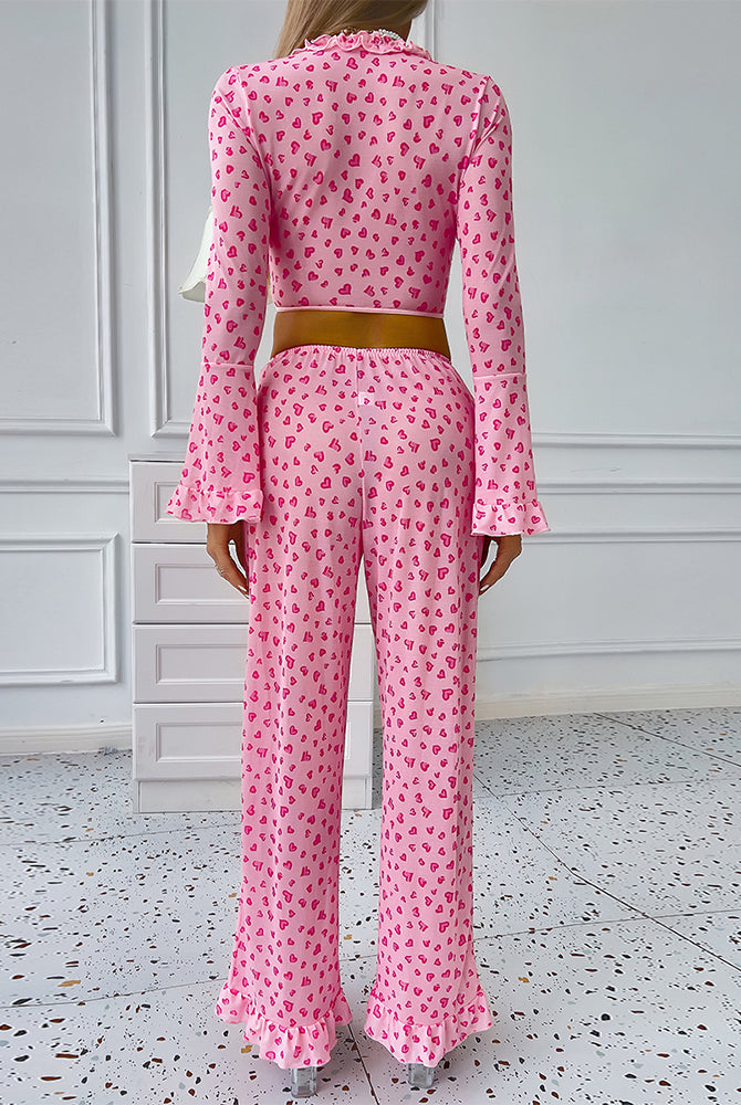 Pink heart print pajama set with ruffled top and pants, comfortable sleepwear