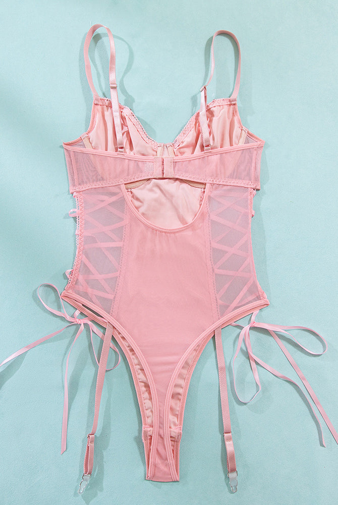 Pink mesh erotic bodysuit with adjustable straps and lace-up details, highlighting feminine charm.