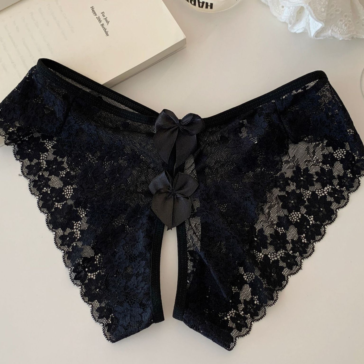 Black sheer floral lace panties with scalloped edges and double back bows