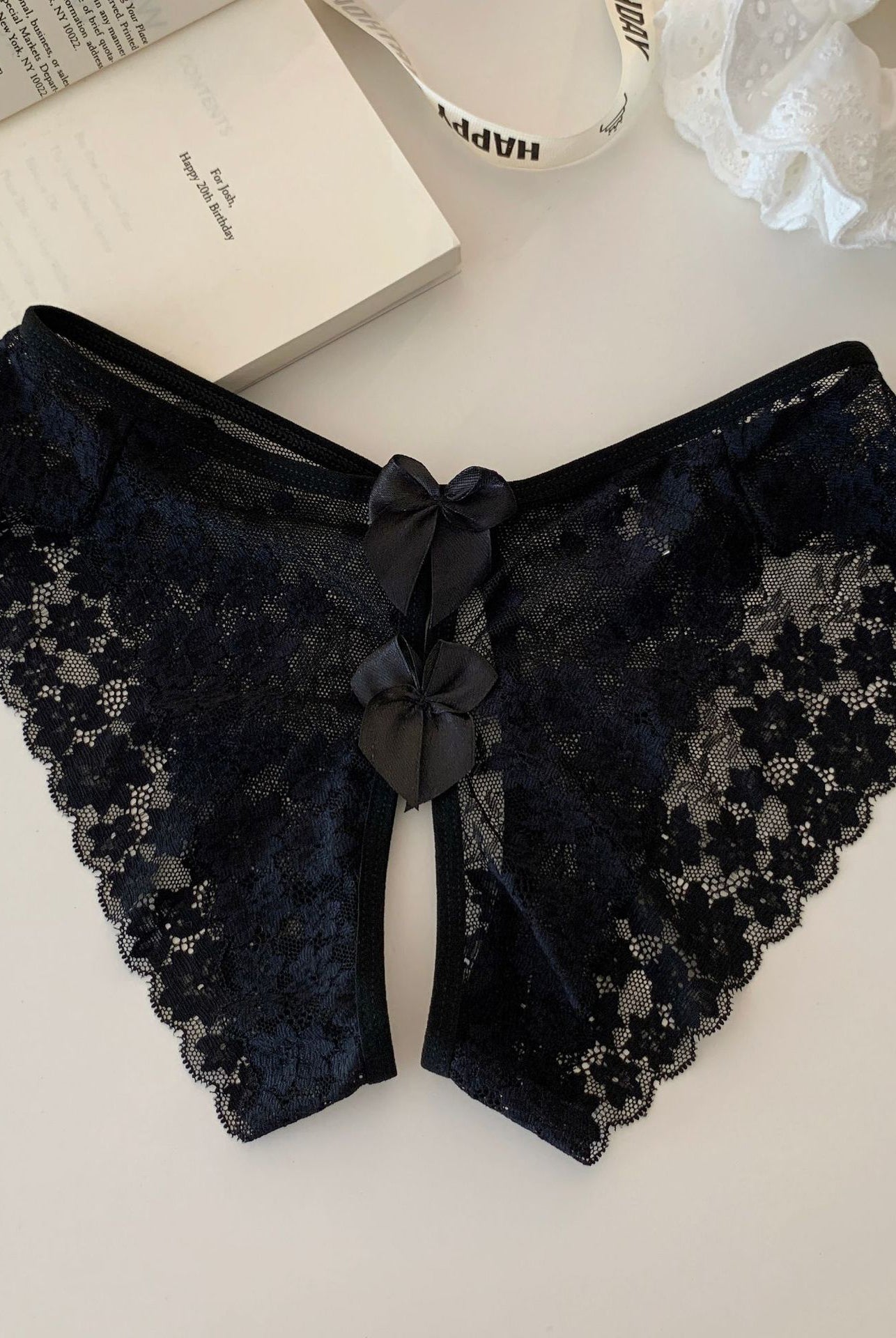 Black sheer floral lace panties with scalloped edges and double back bows