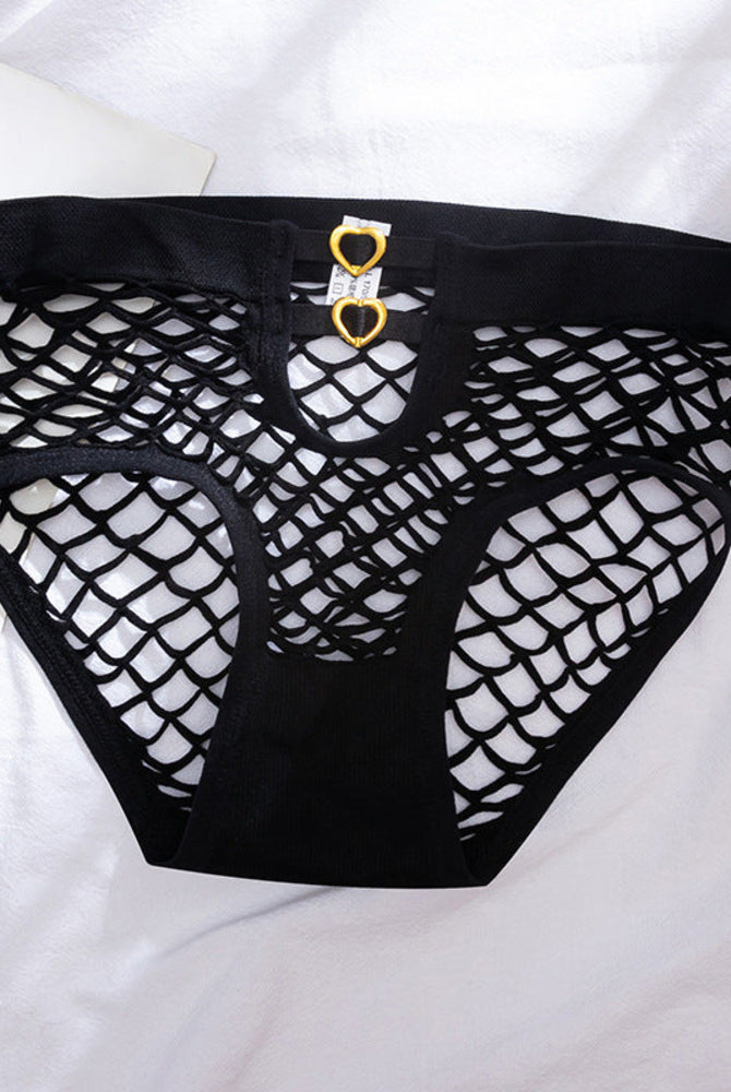 Black fishnet cutout panties laid flat, heart ring accents and lattice mesh