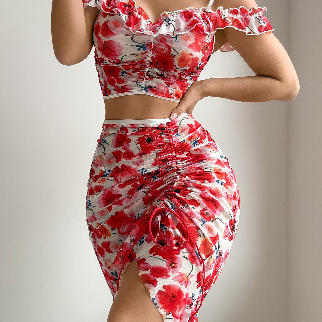 Red floral mesh off-shoulder crop top and ruched mini skirt with tied front