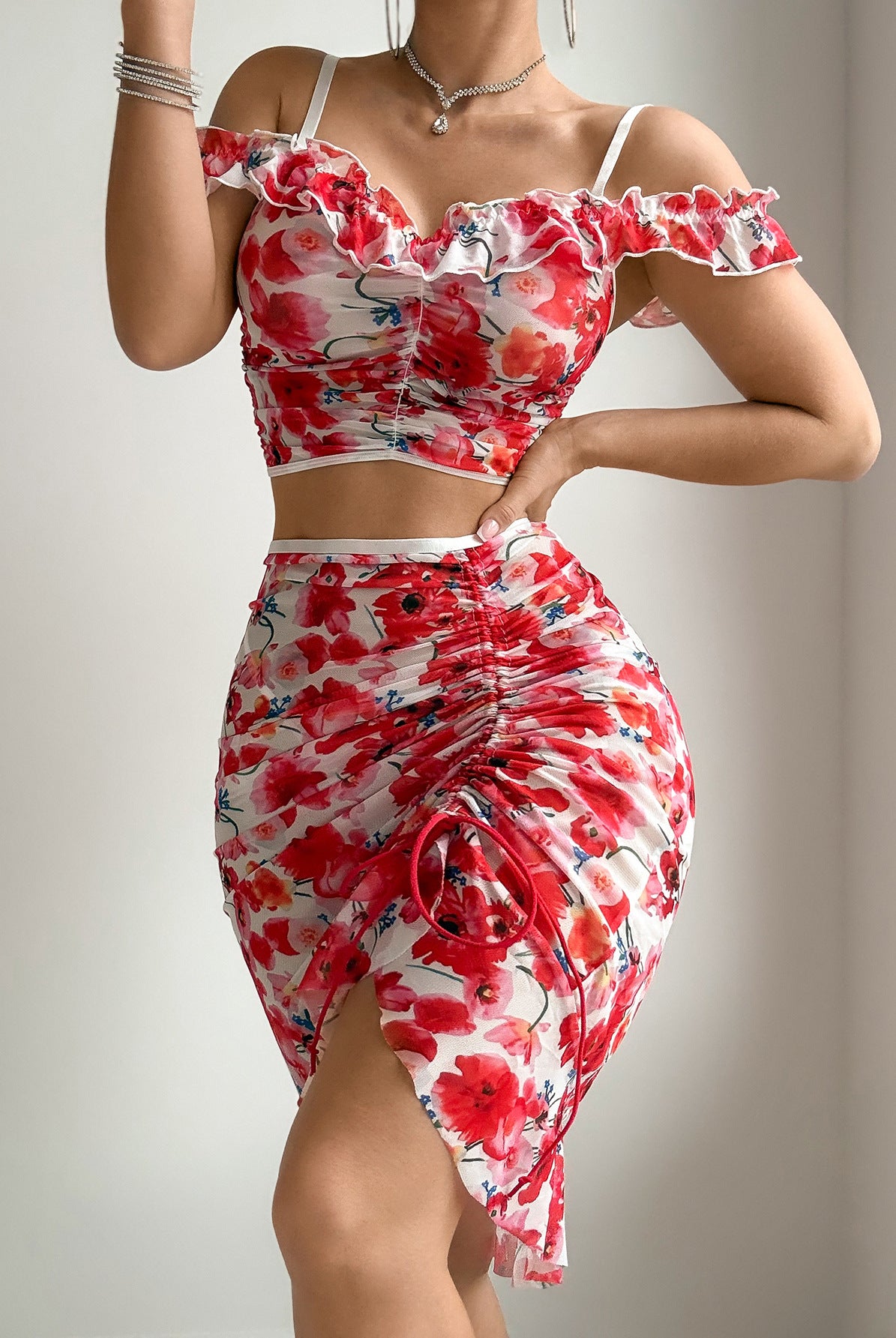 Red floral mesh off-shoulder crop top and ruched mini skirt with tied front