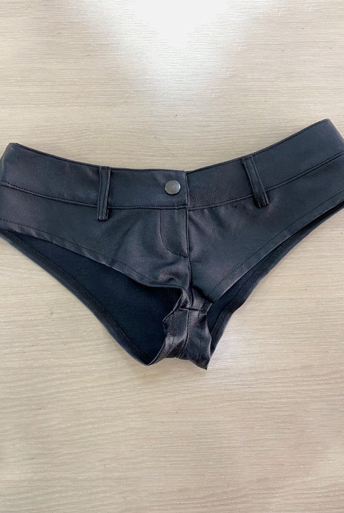 Black faux leather low rise booty shorts, flat lay with snap button front