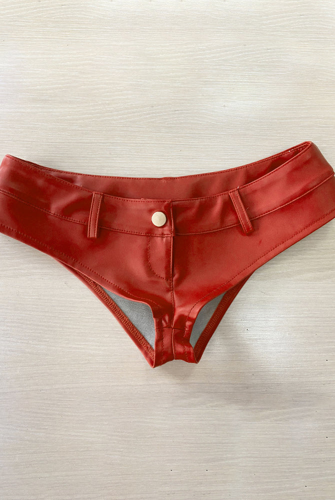 Red faux leather low rise booty shorts, flat lay with snap button front