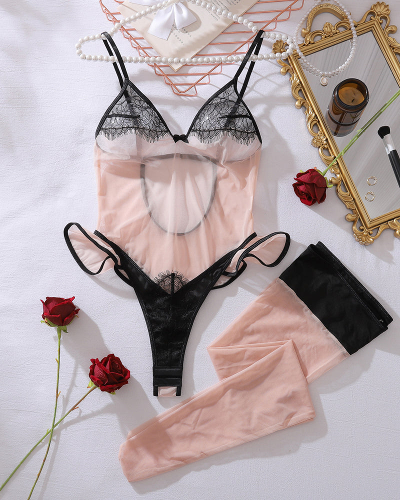 Black lace sheer bodysuit with matching thigh-high stockings, set laid flat
