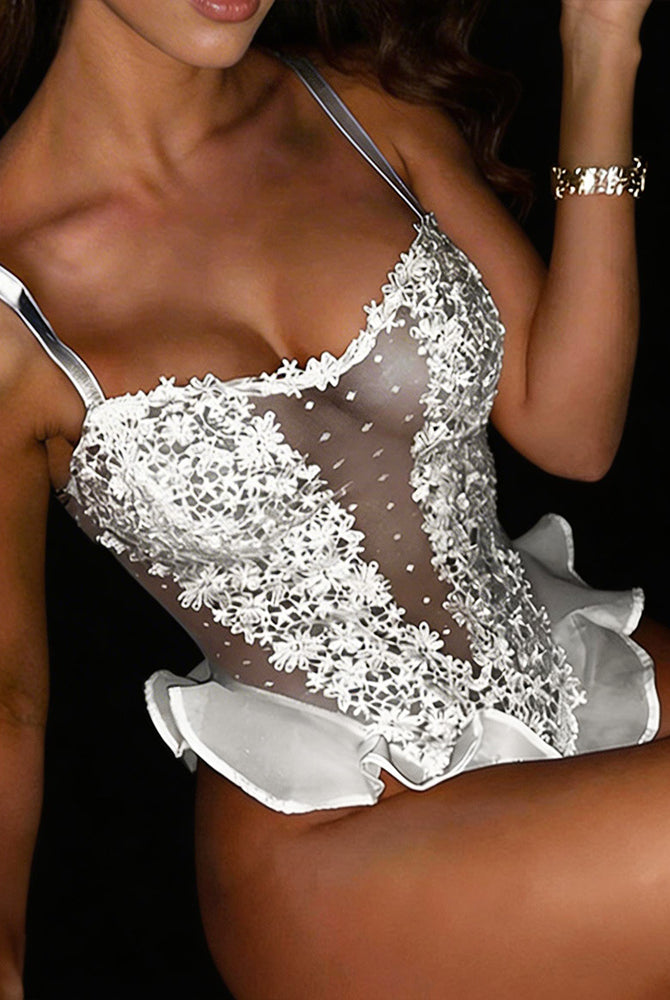White sheer floral lace bodysuit with ruffle hem, scalloped neckline and thin straps.