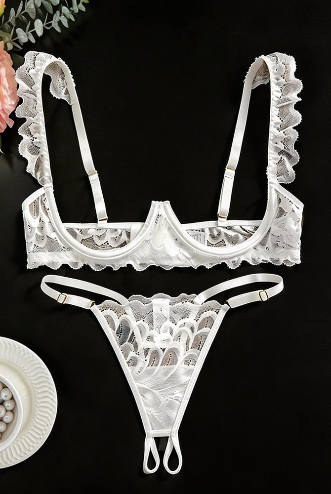 White lace cupless bra and crotchless thong with scalloped edges and adjustable straps