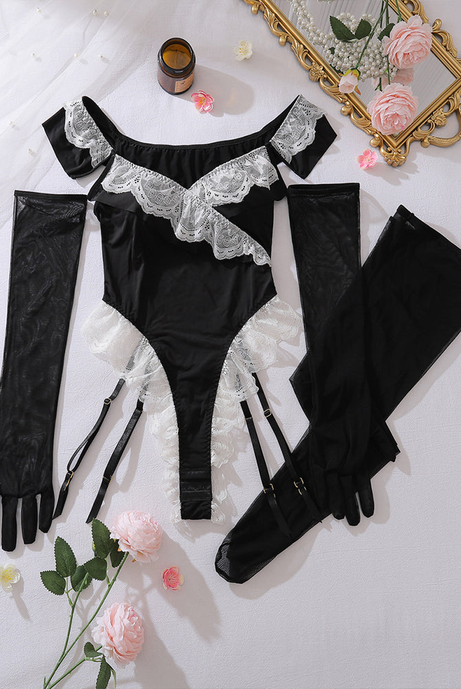 Black off-shoulder lace maid bodysuit with sheer gloves and garter stockings, laid flat