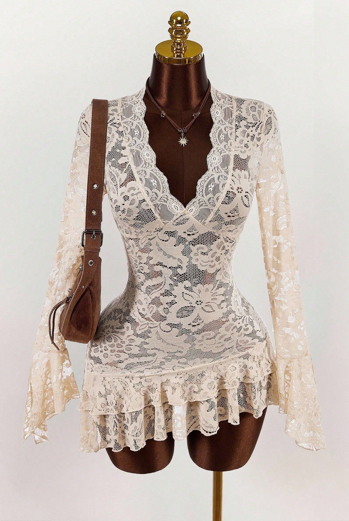 Cream lace mini dress with deep V neckline and layered ruffle skirt