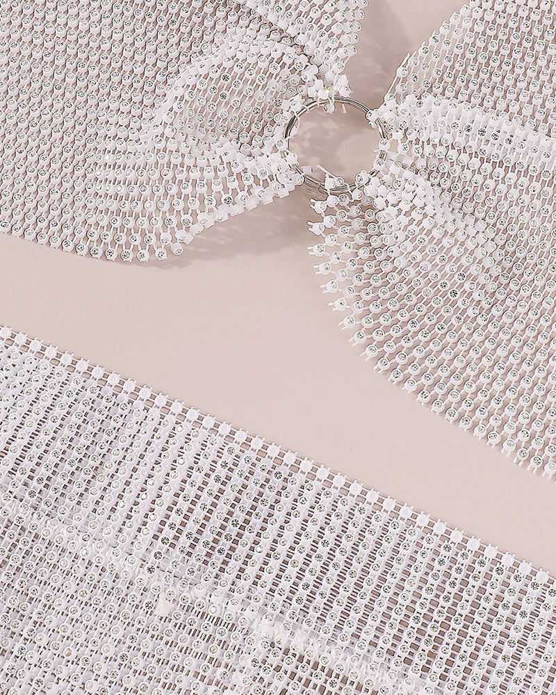 Close-up of white rhinestone fringe fabric with linked metal mesh strands
