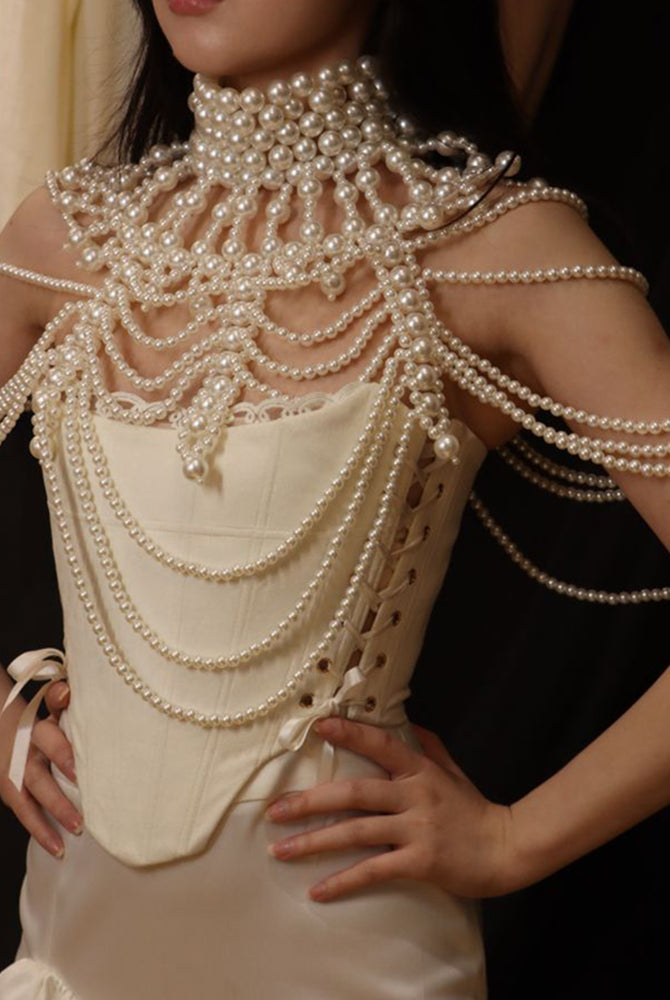 Pearl fringe halter top with layered pearl body chain and fringe drape at upper torso