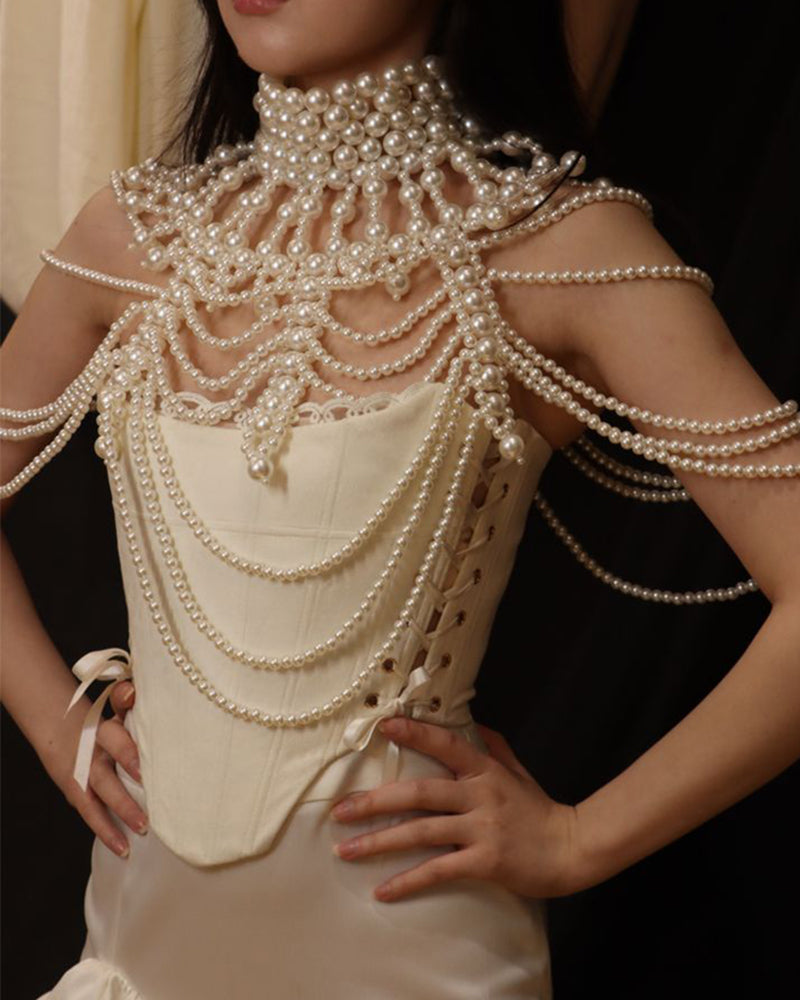 Pearl fringe halter top with layered pearl body chain and fringe drape at upper torso