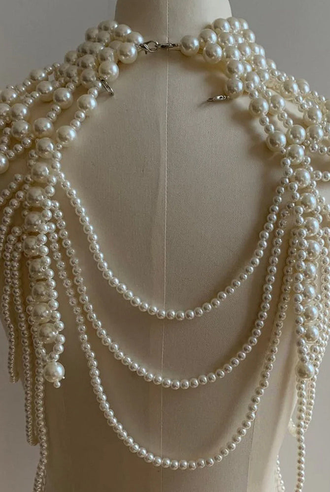 Pearl fringe halter top with layered pearl body chain, pearl strands and clasp at collar