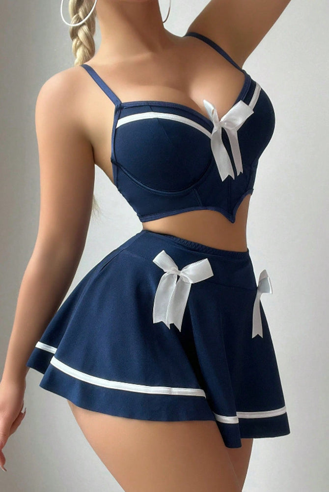 Navy sailor-style lingerie set, bow crop top and flared mini skirt with white trim