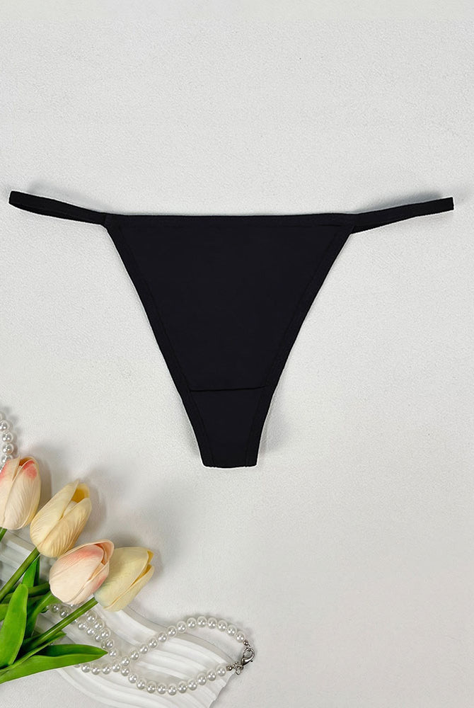Low-rise thong panties in black with smooth seamless design and soft coverage.
