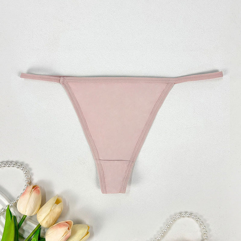 Low-rise thong panties in blush pink with seamless soft stretch fabric.