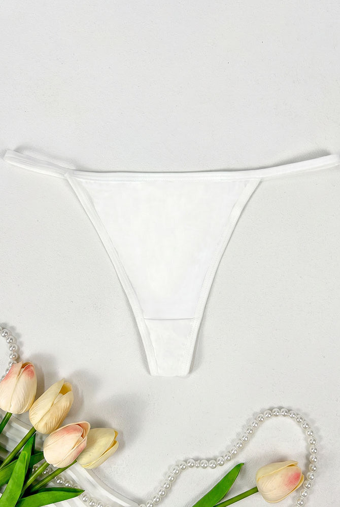 Low-rise thong panties in white with smooth seamless design and soft coverage.