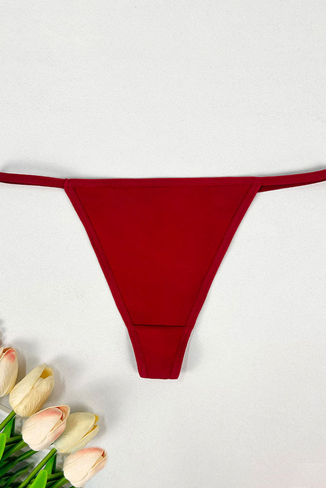 Low-rise thong panties in red with seamless soft stretch fabric and low-rise fit.