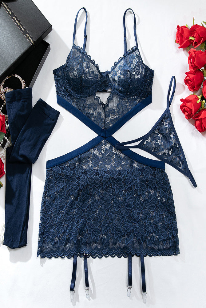 Navy lace babydoll chemise set laid out with bra top, garter straps, and stockings