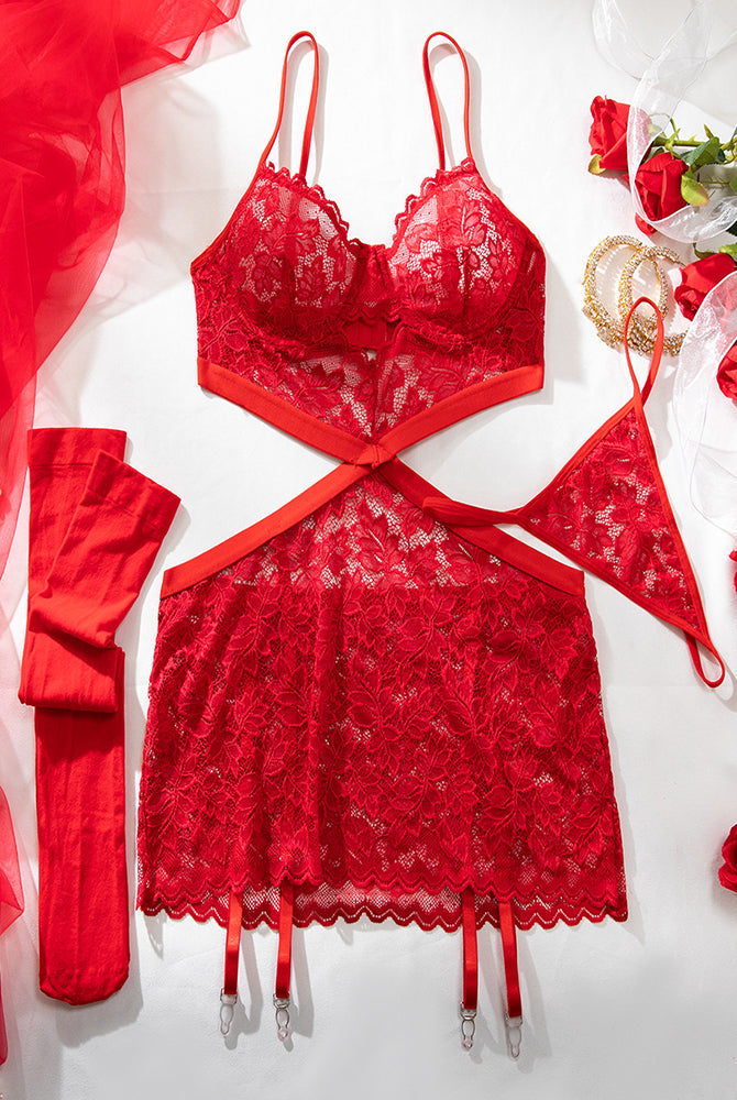 Red lace babydoll chemise set laid out with bra top, garter straps, and stockings