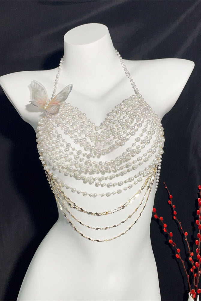 White pearl halter top on mannequin with butterfly applique and layered bead drape, gold chains