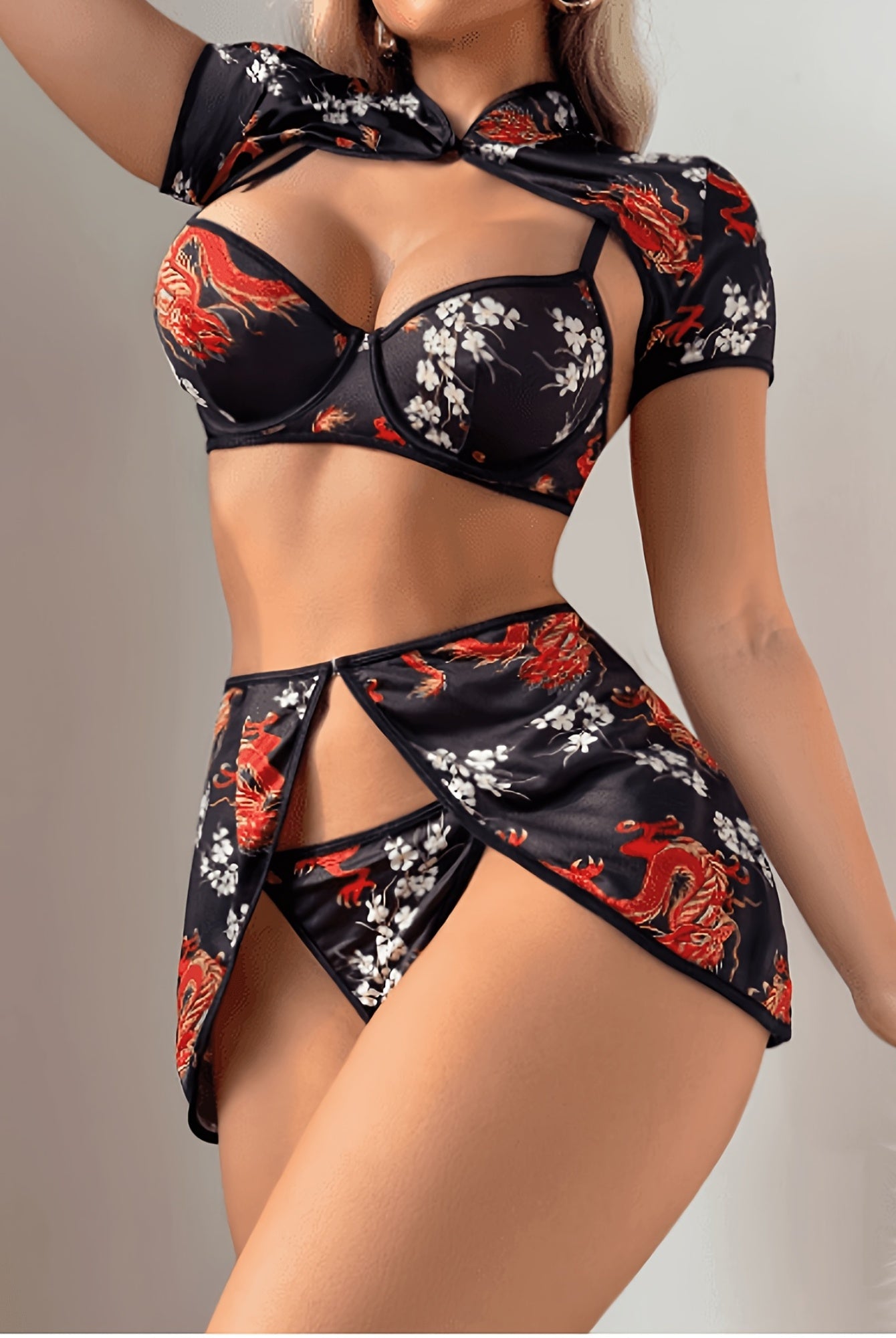 Black strappy lingerie set with dragon and floral print, cutout mini skirt