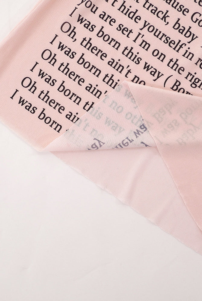 Pink-beige sheer mesh fabric with black lyric text print