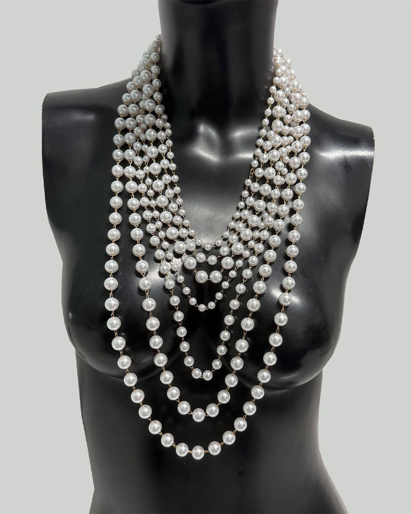 Pearl body chain with multi-row beaded ropes forming a V at the chest