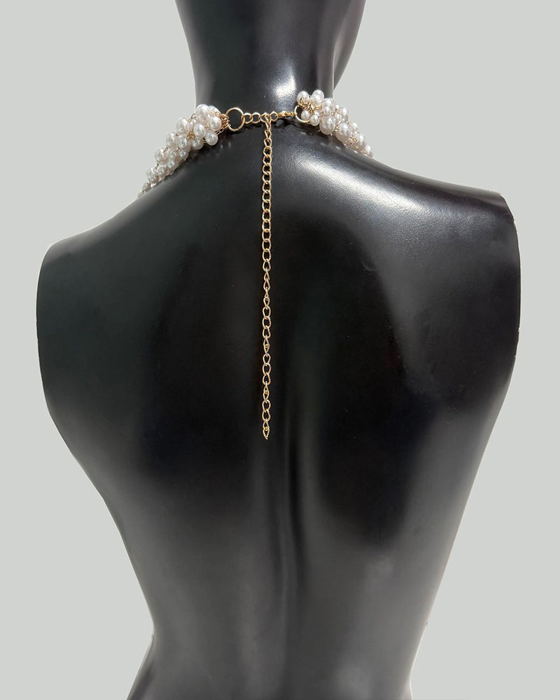 Pearl body chain with gold-tone chain and clasp; pearl bands sit at shoulders
