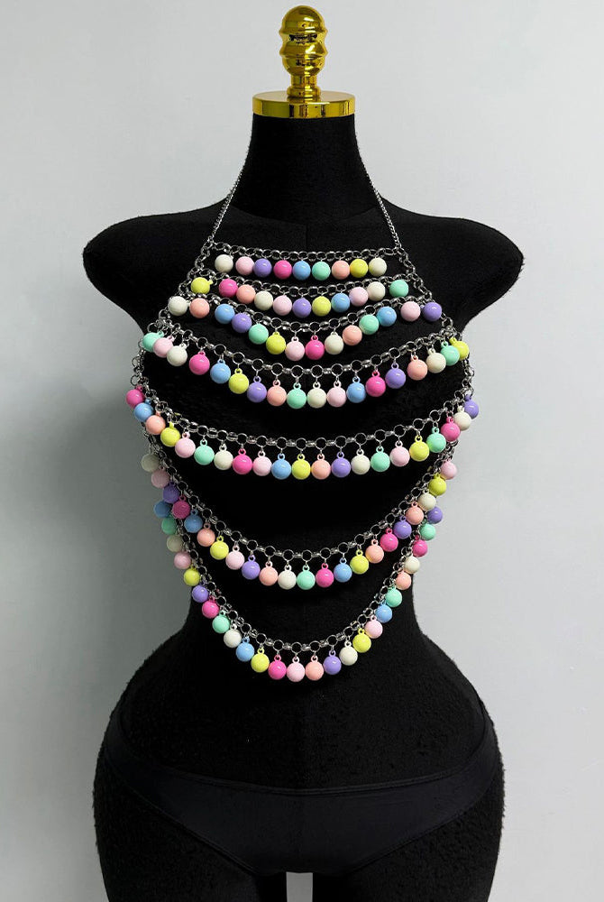 Multicolor beaded body chain on mannequin, layered pom-pom strands with chain links