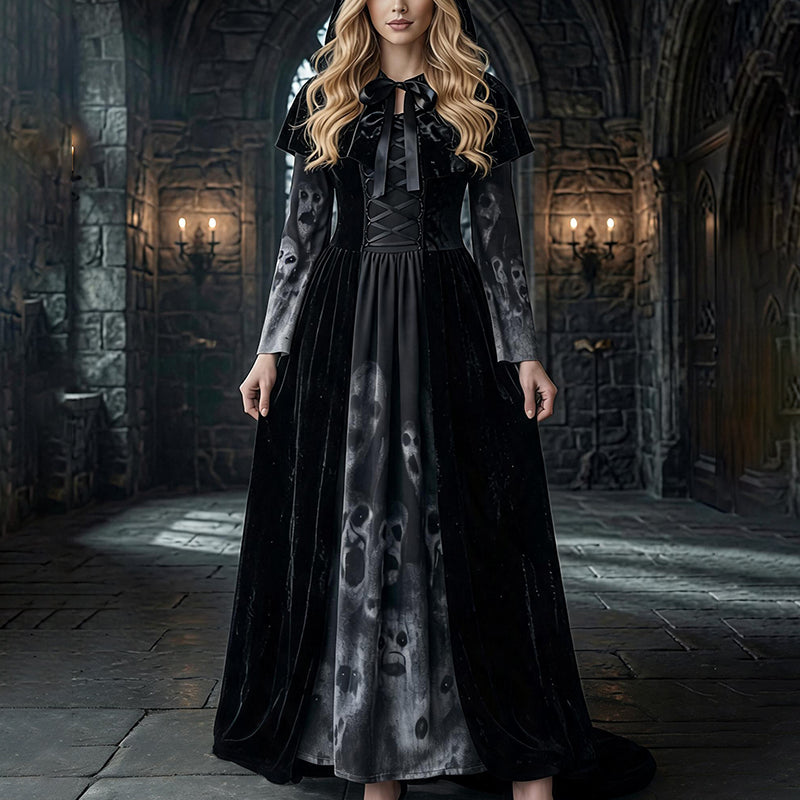 Black maxi dress with long sleeves, tie-neck bodice, and skull-print cape and skirt panels