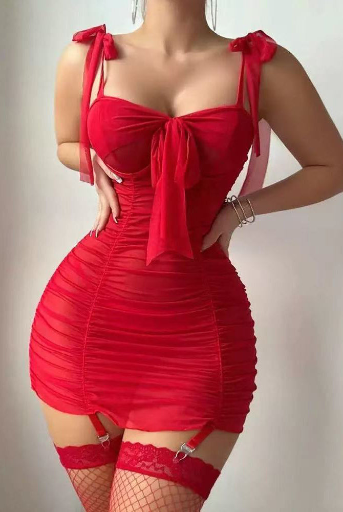 Red ruched mesh mini dress with bow tie straps, garter stockings, and fishnet tights
