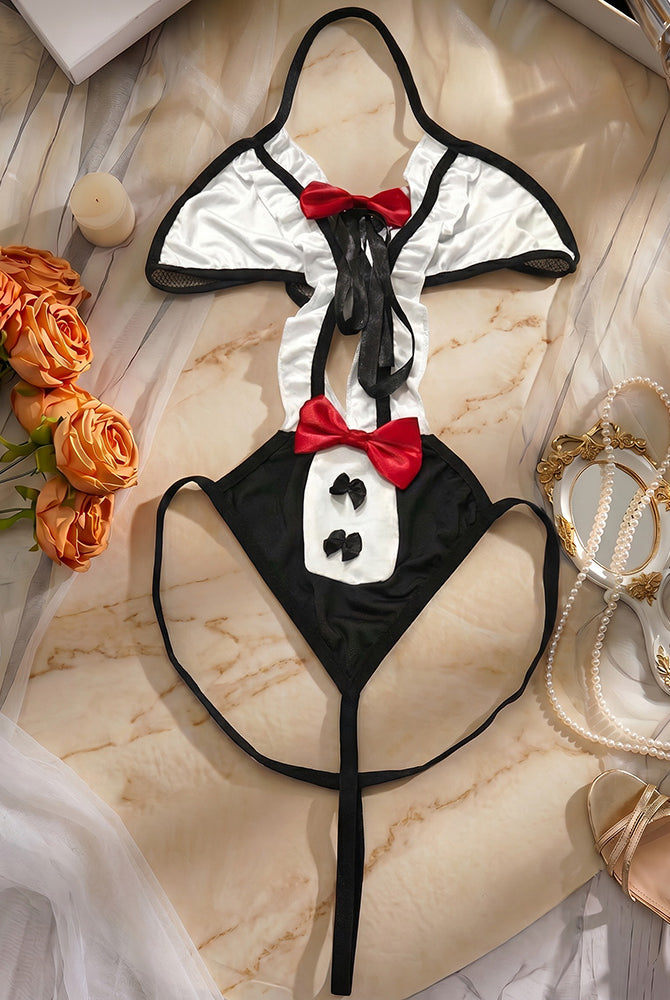 Black and white bunny bodysuit with red bow bib and ruffle trim, laid flat